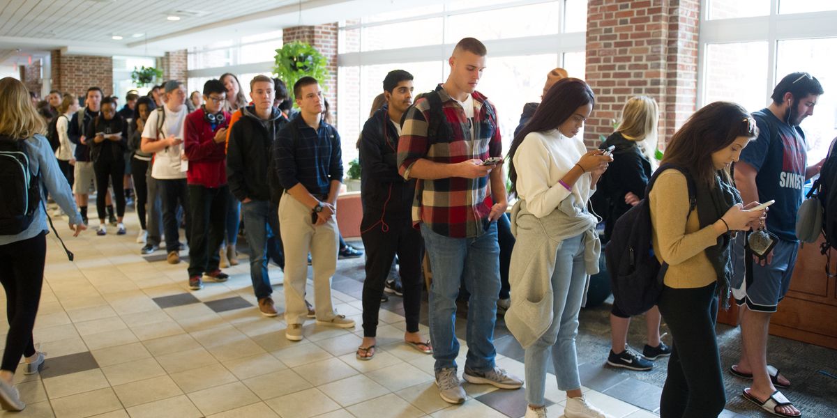 Millennial voters standing in line.