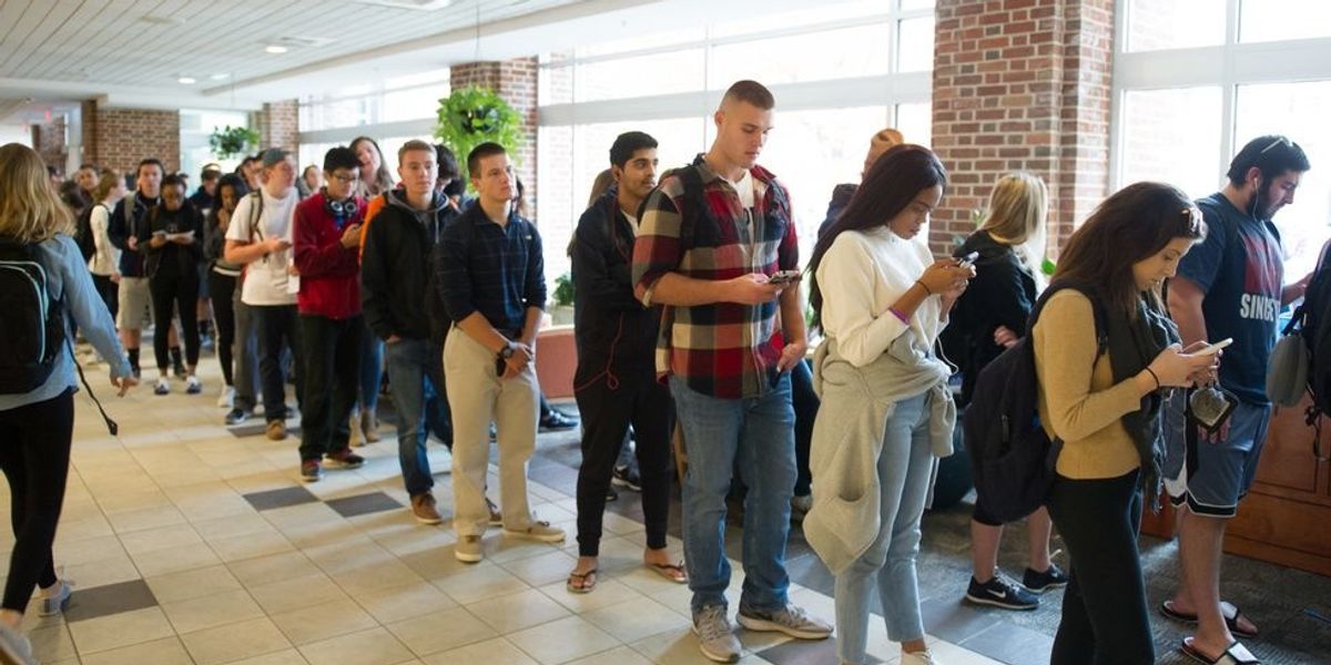 Millennial voters standing in line.