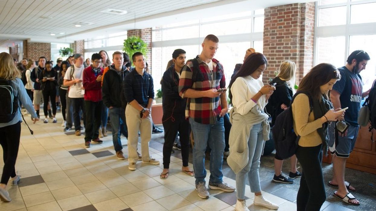 Millennial voters standing in line.