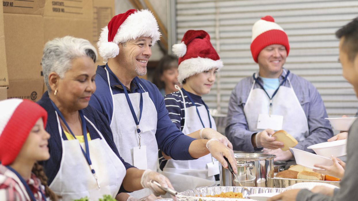 Multi-ethnic volunteers serves food at soup kitchen at Christmas