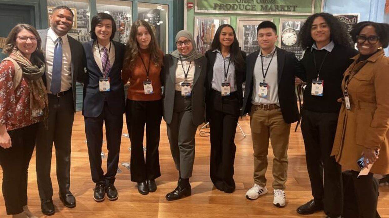 Nine young adults posing together