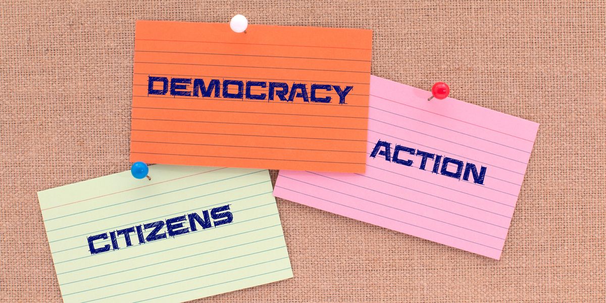 Notecards saying "democracy," "citizens" and "action"