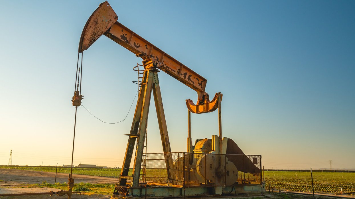 Oil pump at sunset, agricultural field