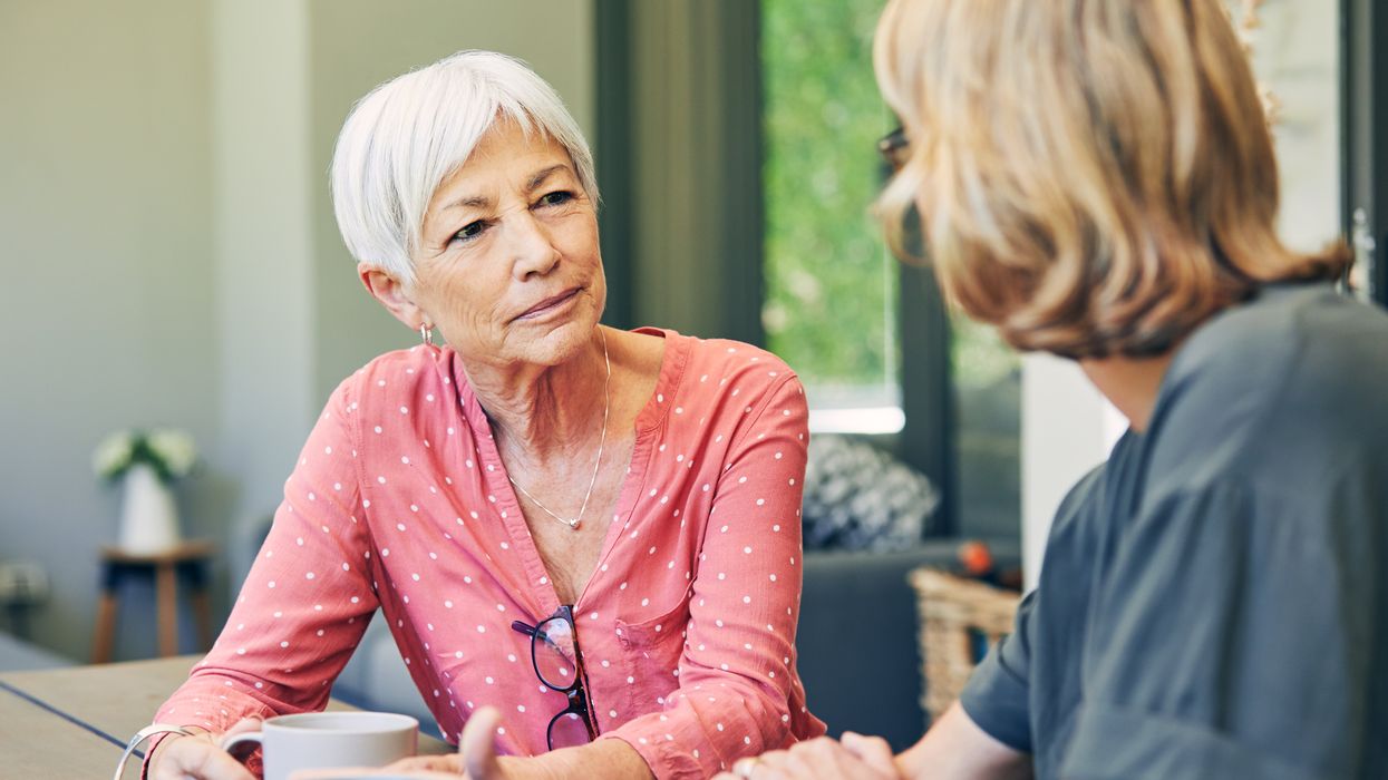 Older woman speaking with another woman