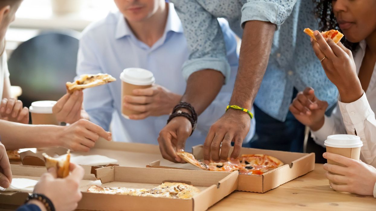 People eating pizza together.
