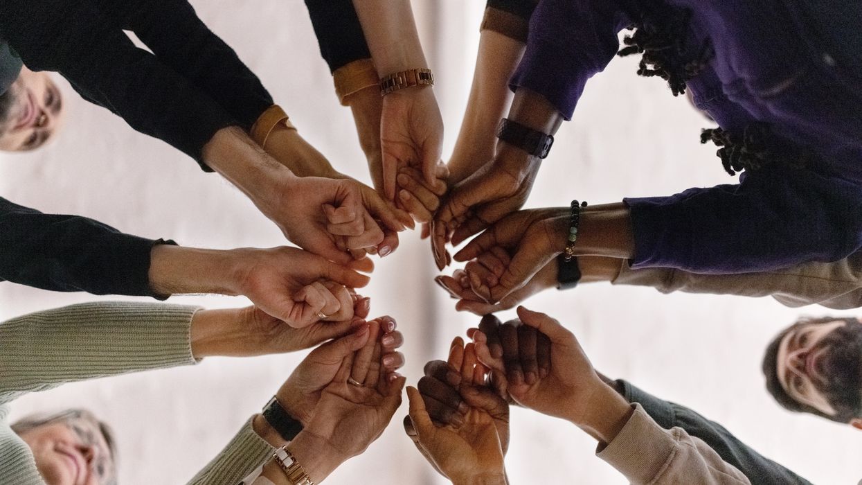 People holding hands in a circle