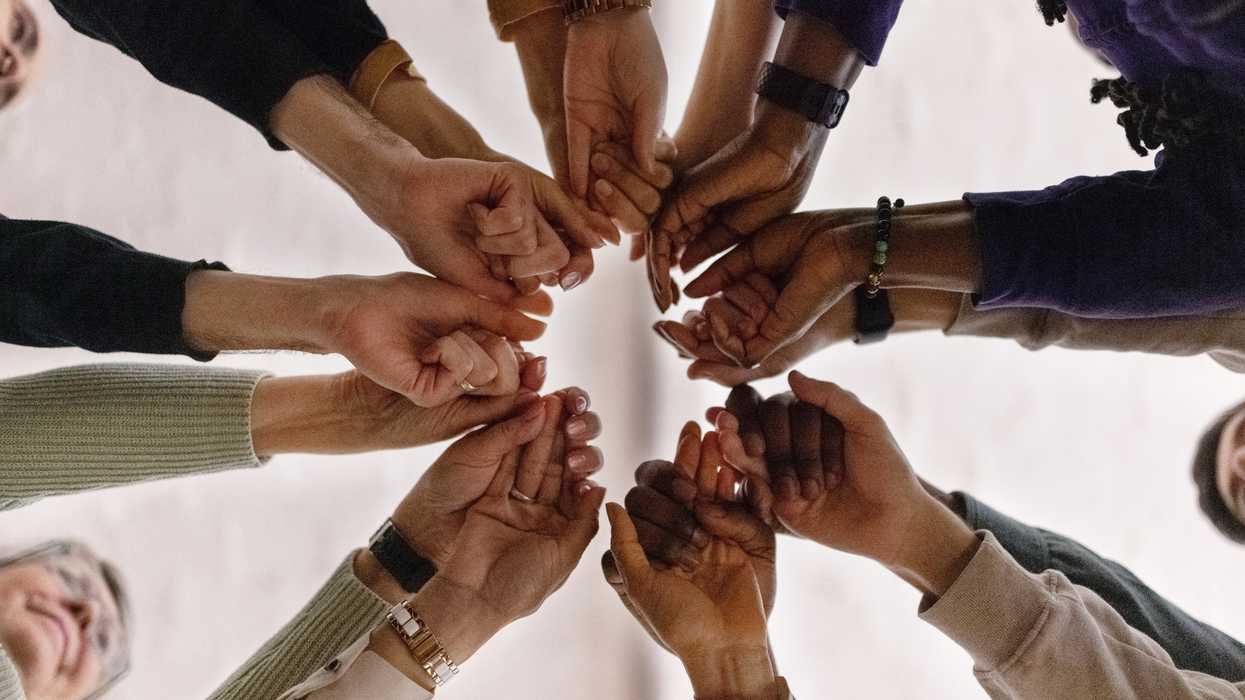 People holding hands in a circle