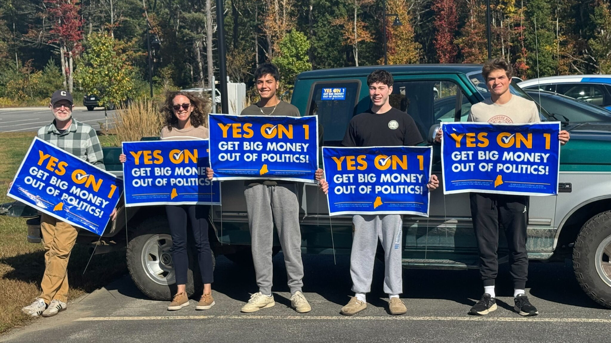 People holiding "Yes on 1" signs