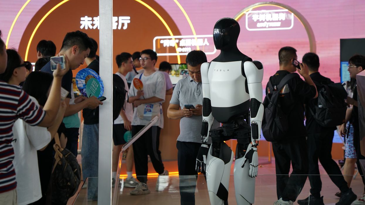 People looking at a humanoid robot