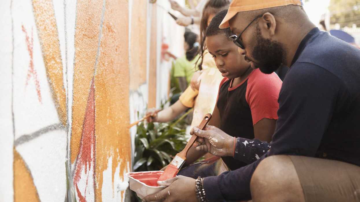 People painting wall together.