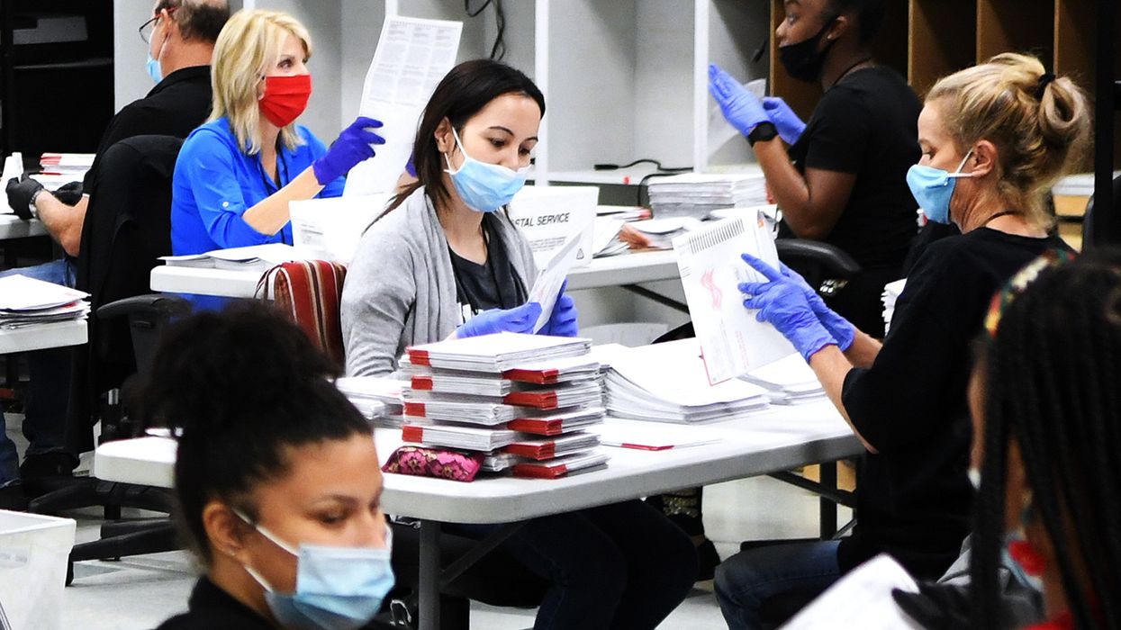 People processing ballots