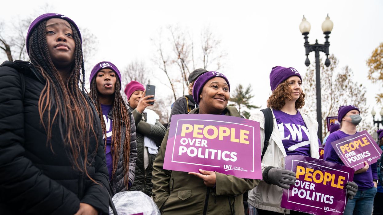 People protesting with "People ovoer politics" signs