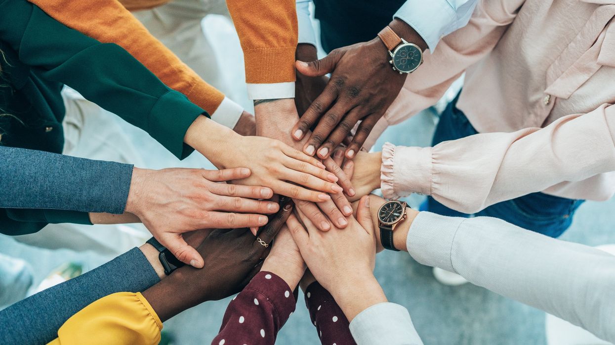 People putting their hands in together.