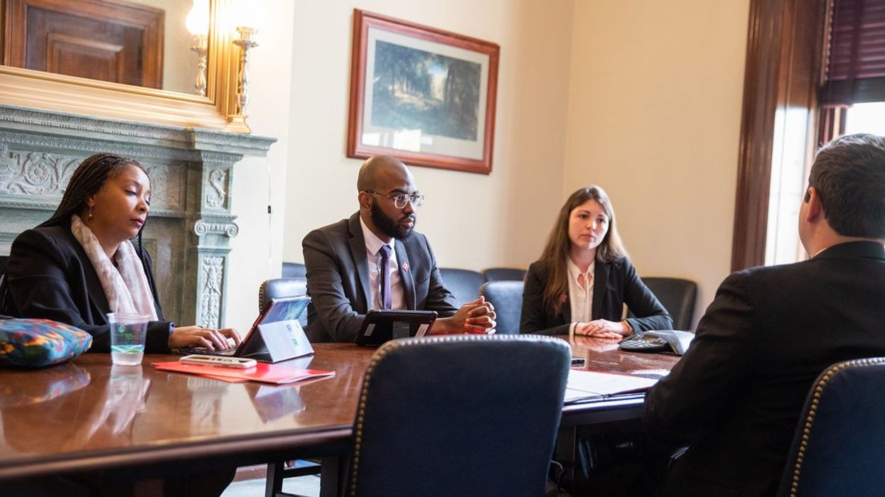 People seated at a conference table