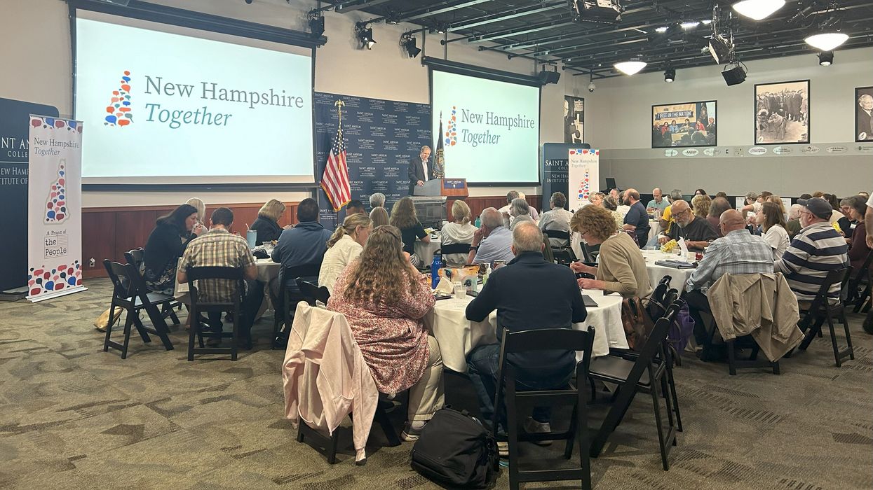 People seated at tables in a large event space