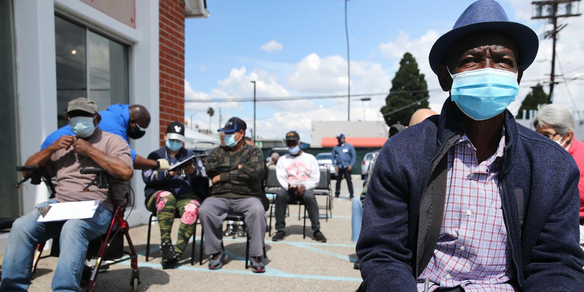 People sit and wait for a Covid vaccine at a predominately Black church.