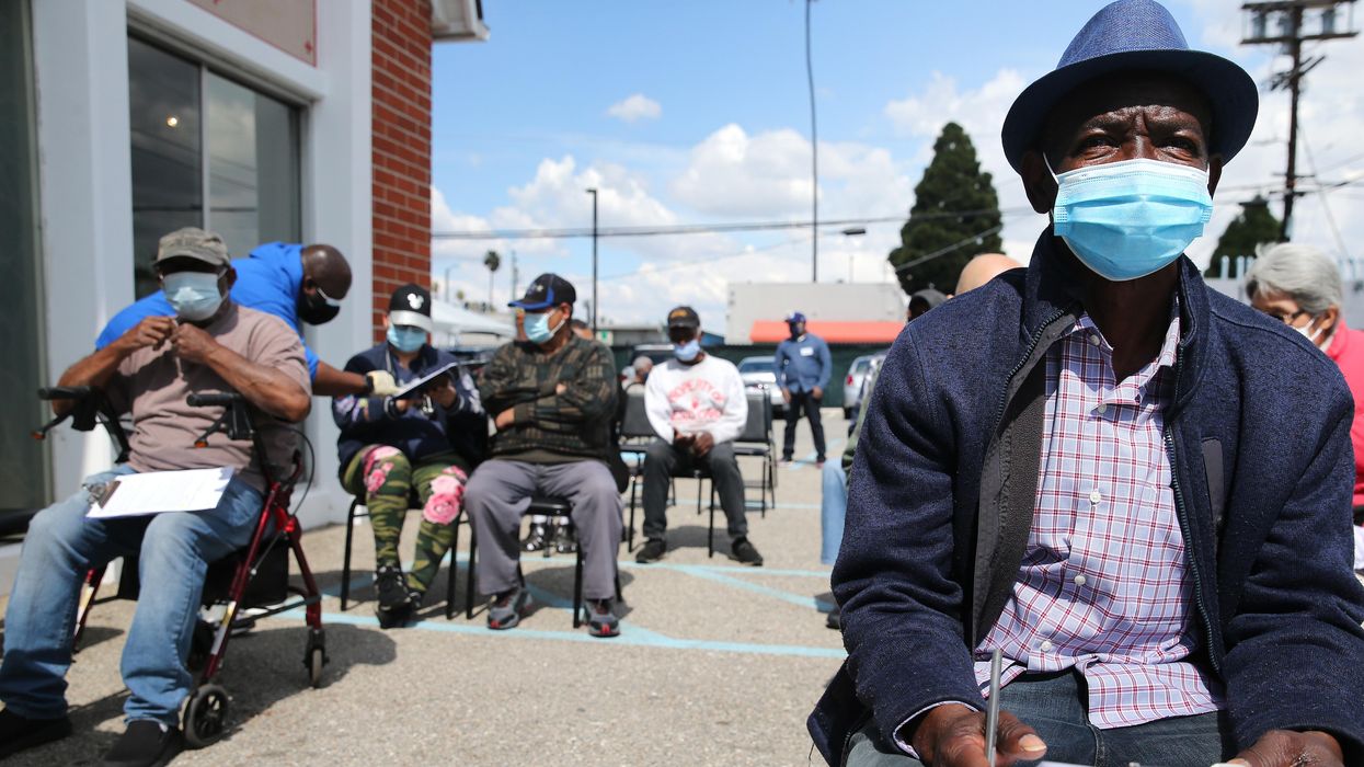 People sit and wait for a Covid vaccine at a predominately Black church.