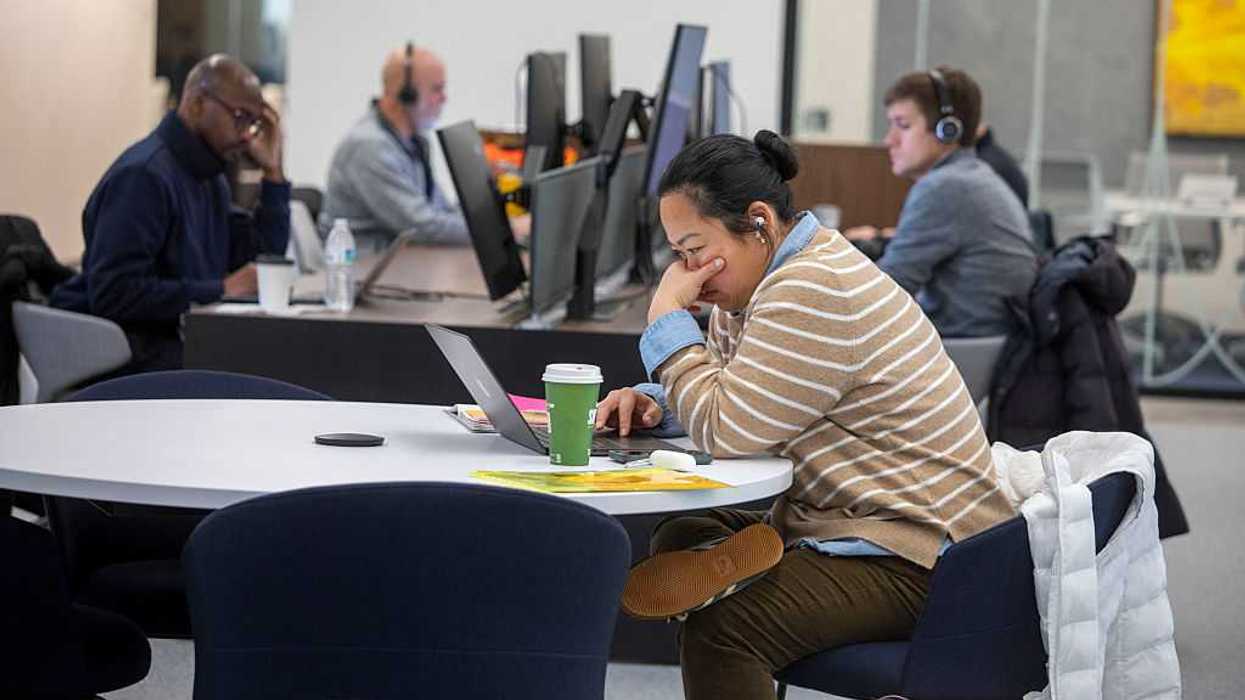People sitting at desks in an office.