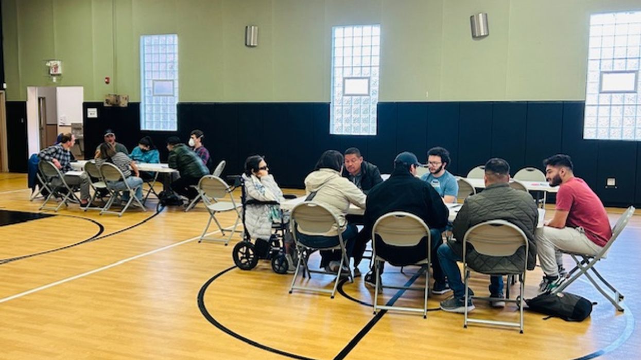 People sitting at tables in a gym