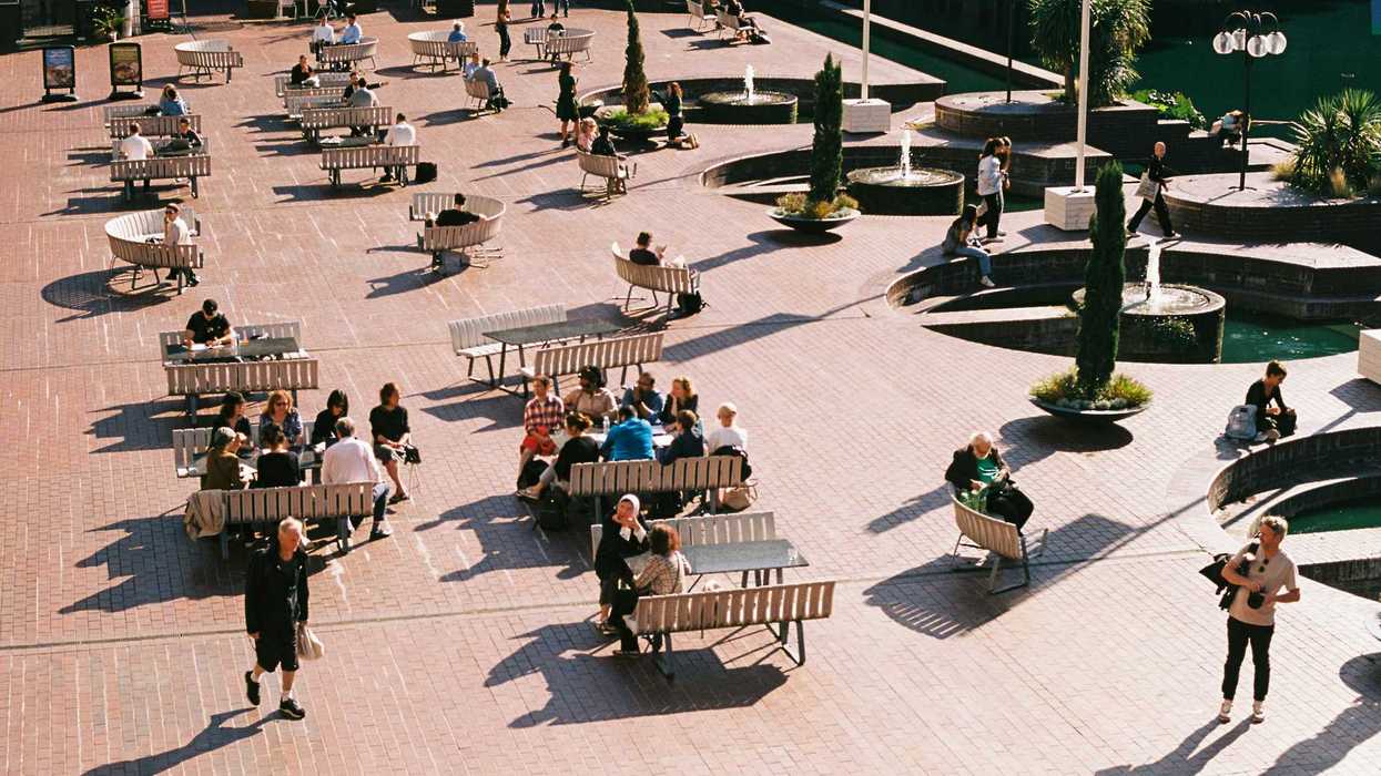 people sitting on top of benches