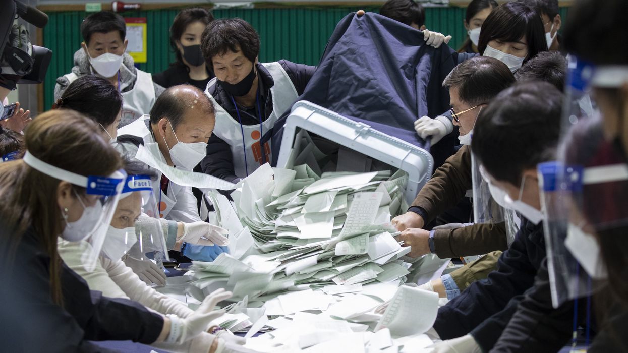 People sorting ballots