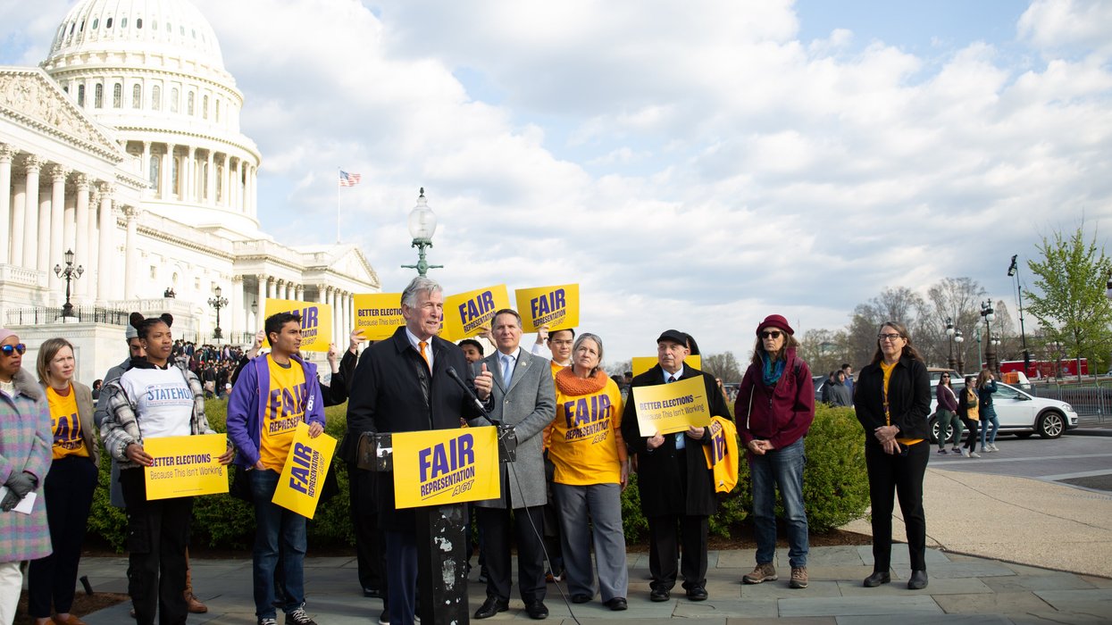People speaking in front of the Capitol