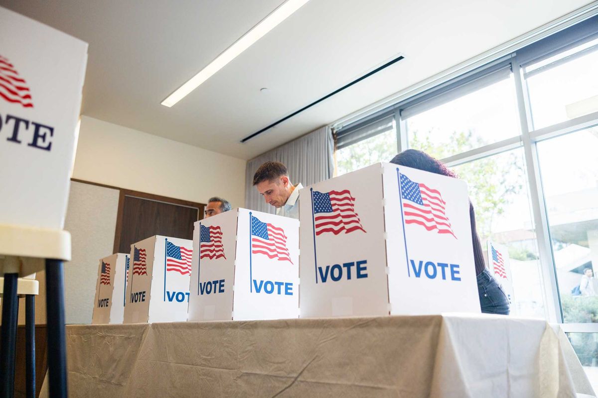 People voting at booths.