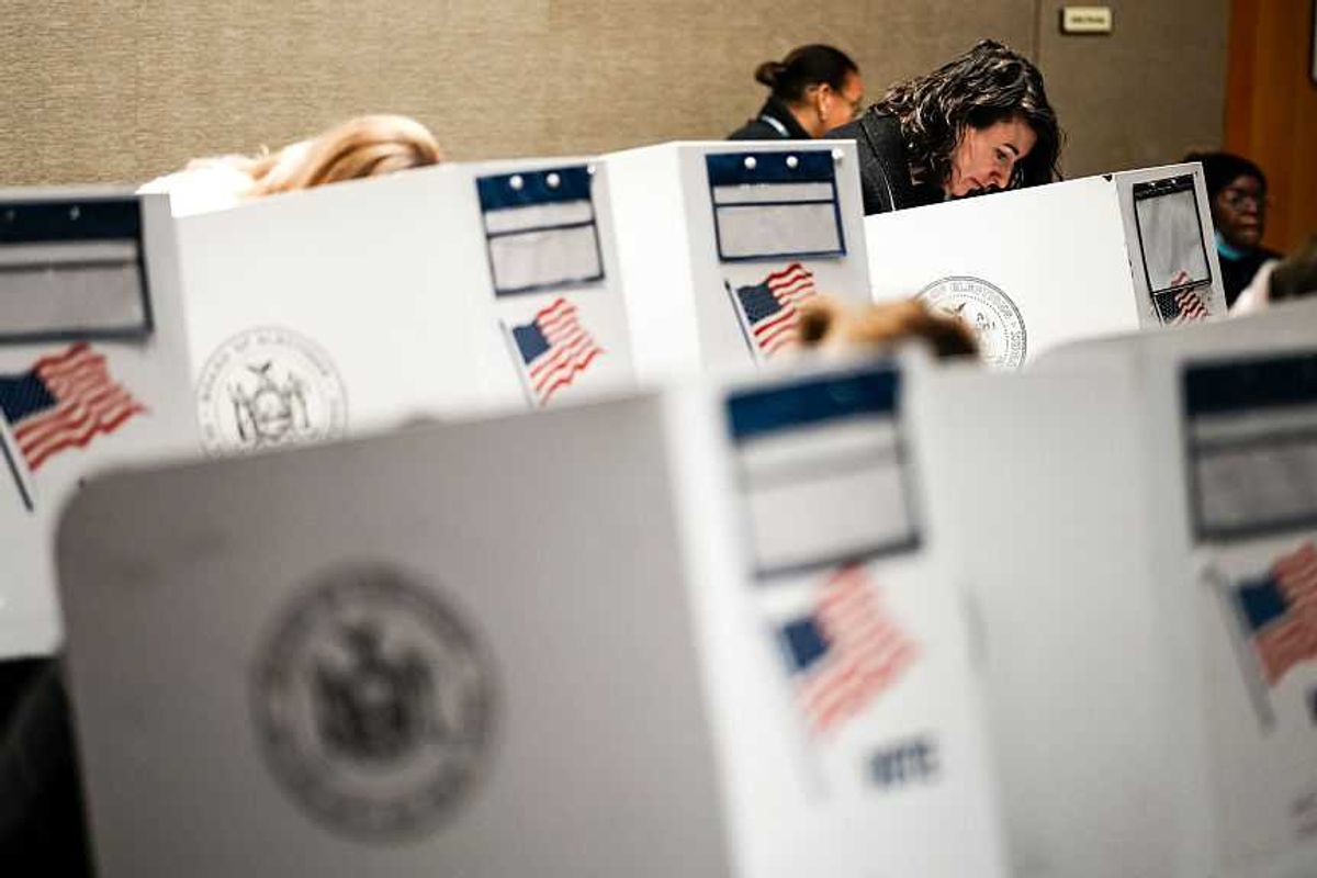 People voting at voting booths.