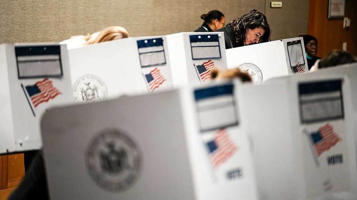 People voting at voting booths.