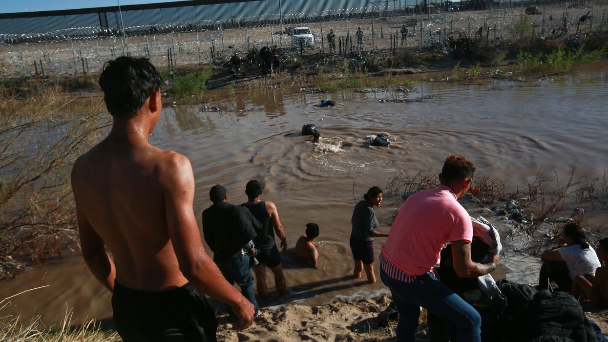 People wading into a river