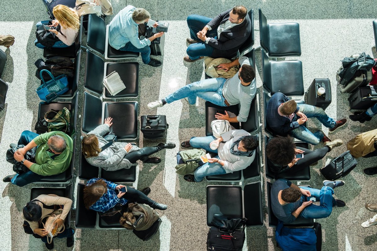 people waiting at airport in departure lounge.