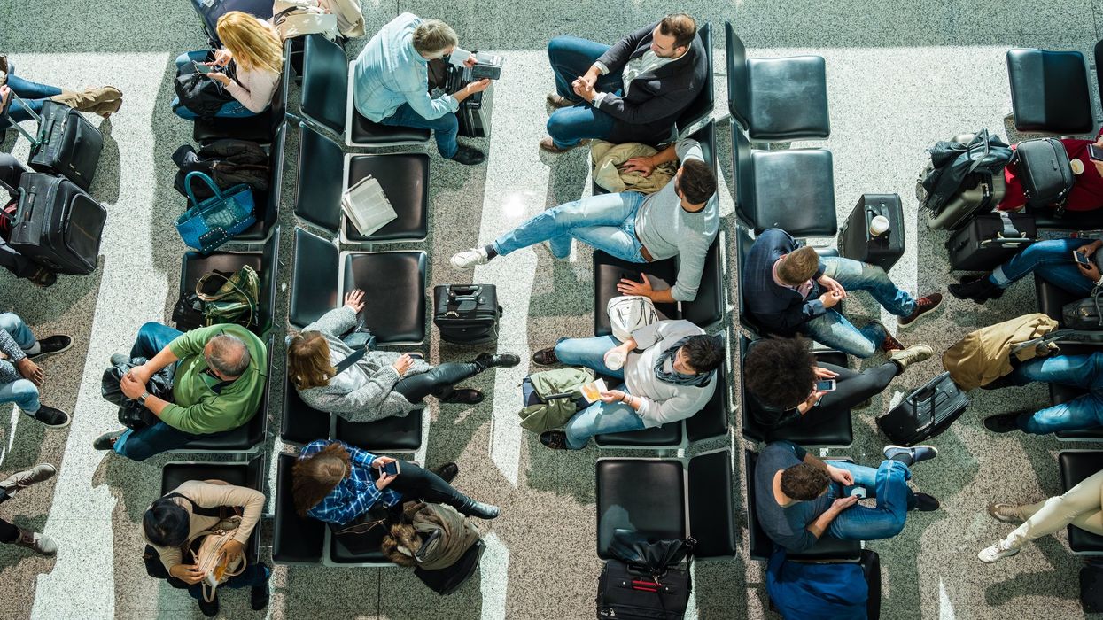 people waiting at airport in departure lounge.