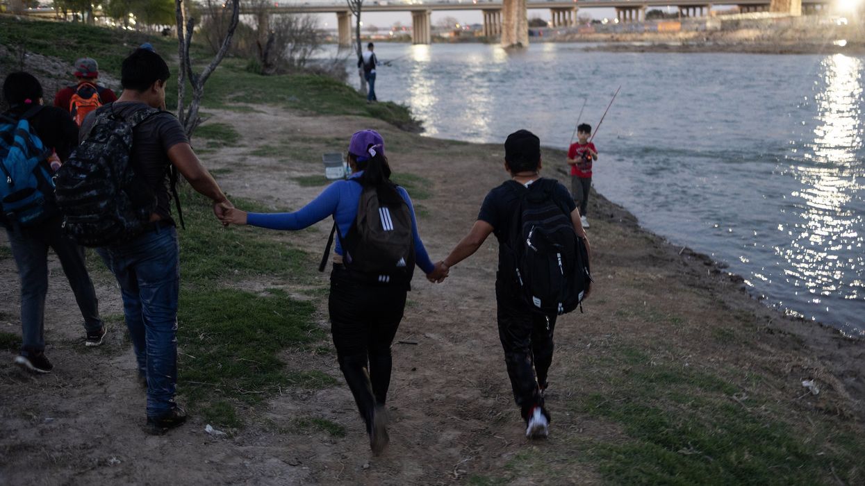 People walking alongside a river