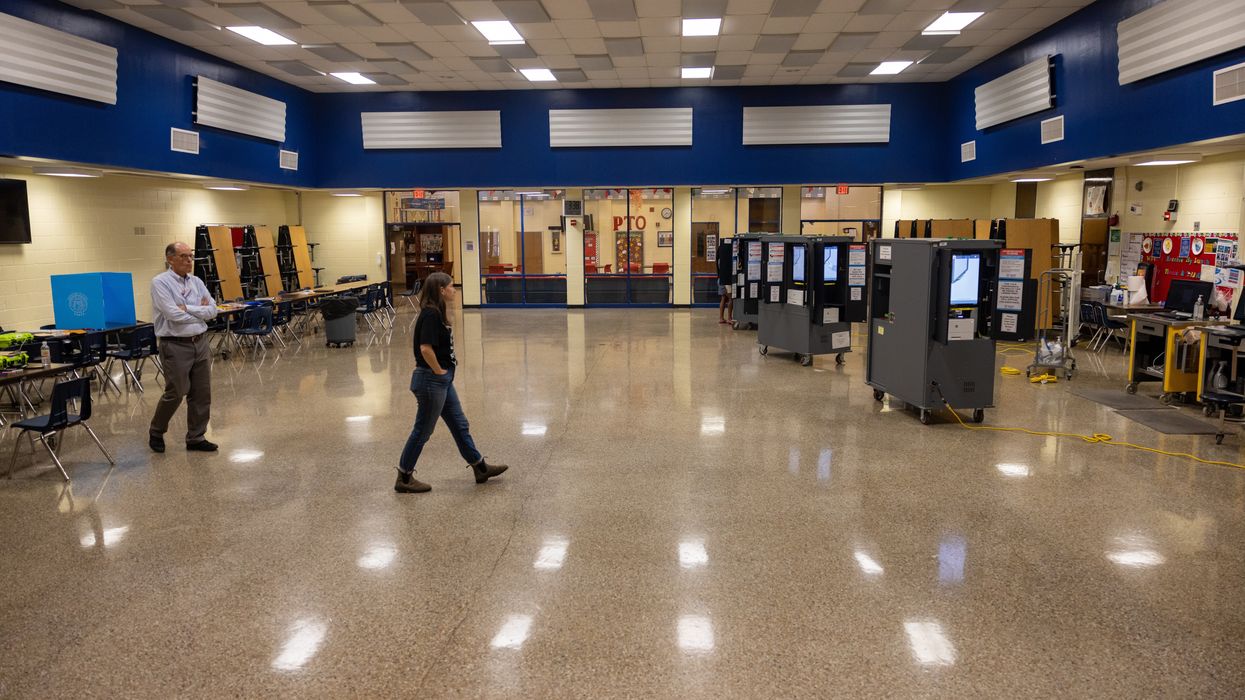 people walking through a polling place