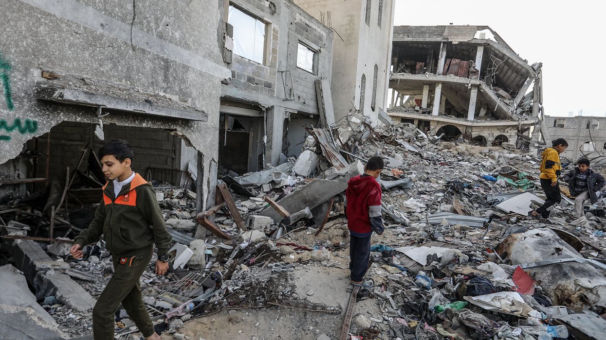 People walking through debris