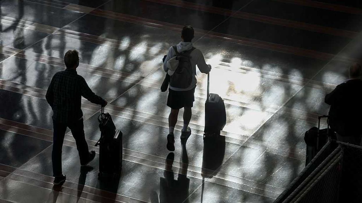 People walking through the airport.
