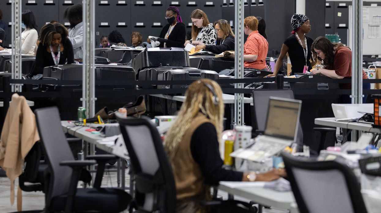 People working in a vote counting center