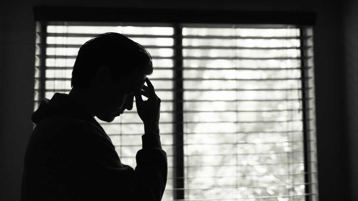 Person at home feeling tired and stressed.
