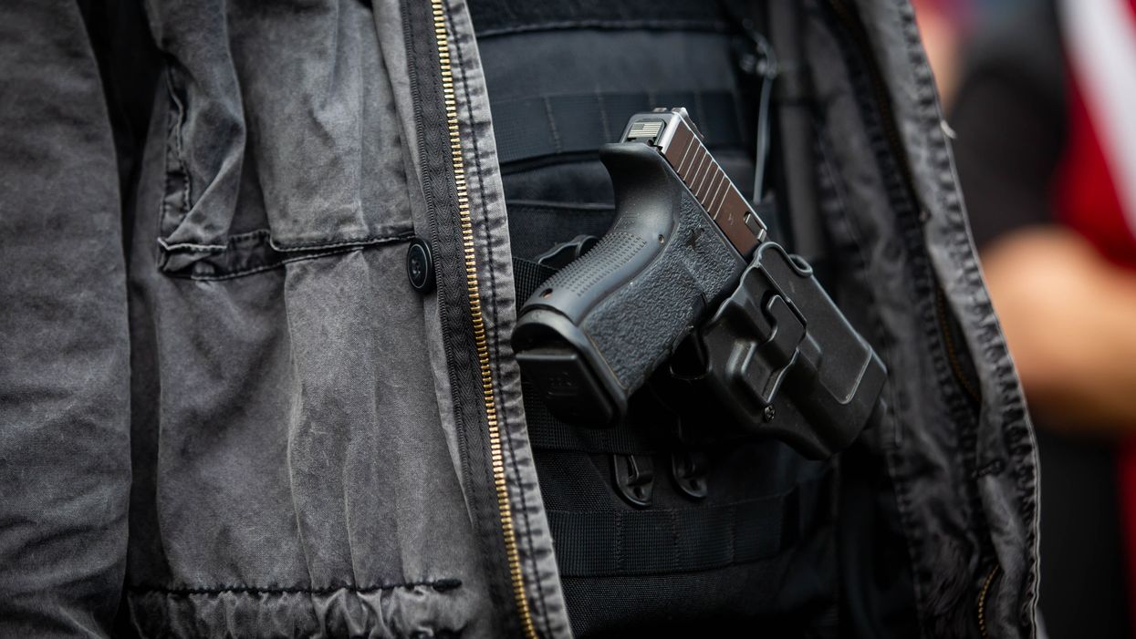 person carrying a gun