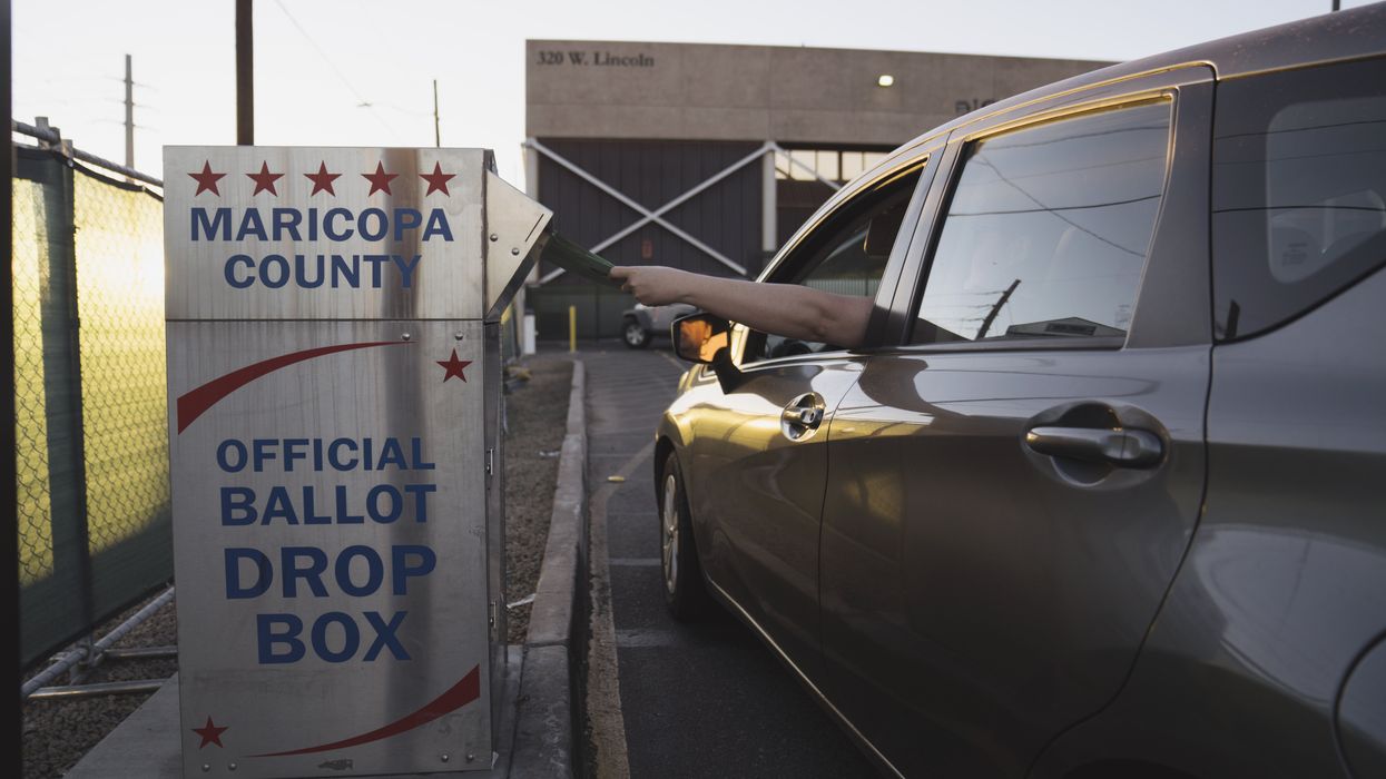 Person dropping off a ballot