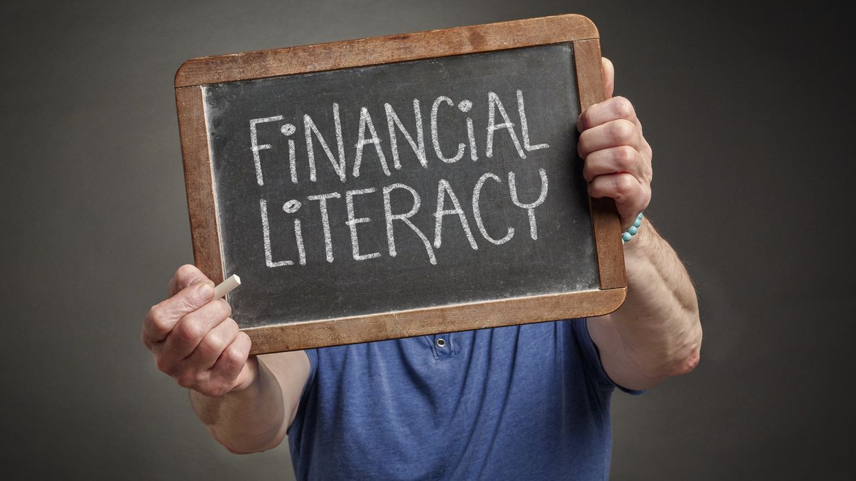 Person holding up a "Financial Literacy" sign
