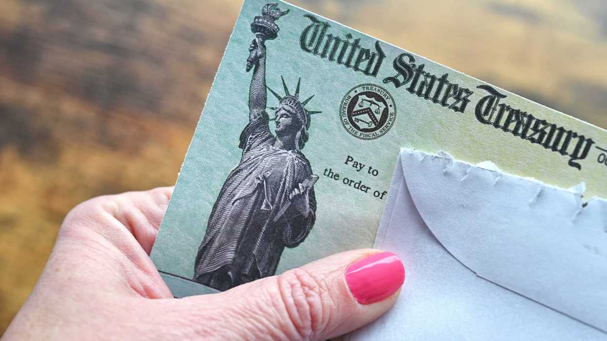Person holds a check from the U.S. Treasury Department.