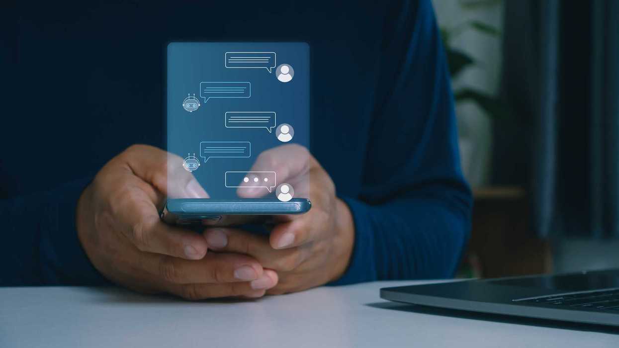 Person using mobile smartphone chatting with AI chatbot, conversation assistant, customer support