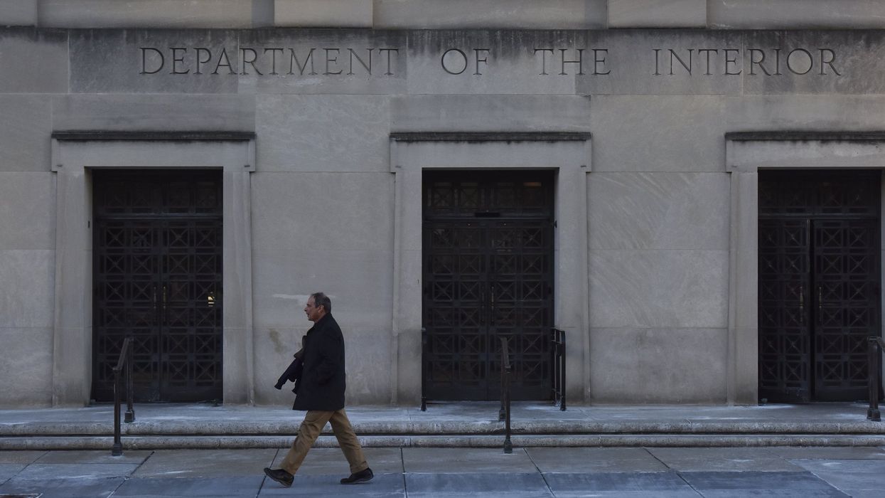 Person walking in front of the Department of Interior