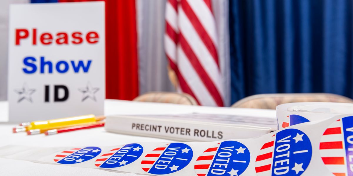 Photo ID sign and "I Voted" stickers