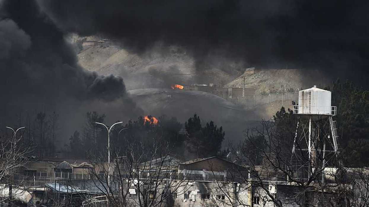 Plumes of smoke rise over the oil depot tanks hit by joint Israel-U.S.