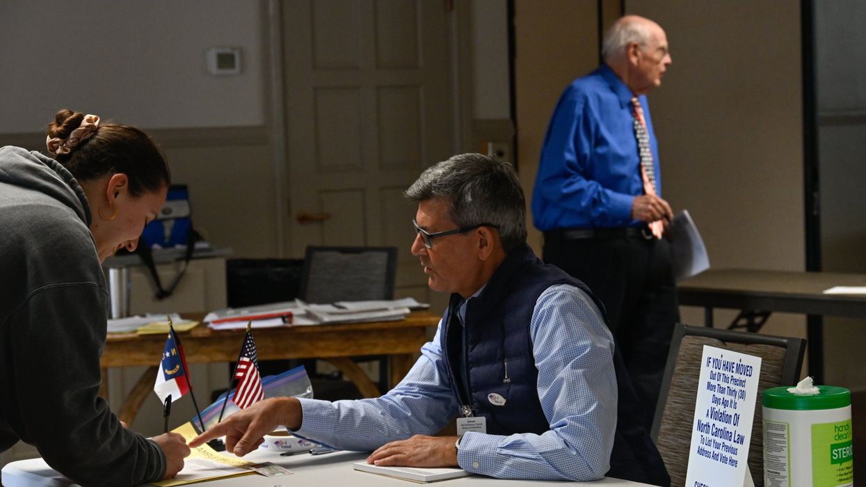 Poll worker helping a voter