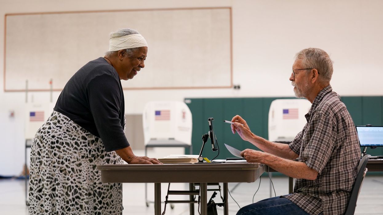 Poll worker helping a voter