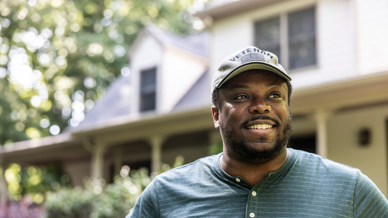 Portrait of U.S. military veteran in front of home