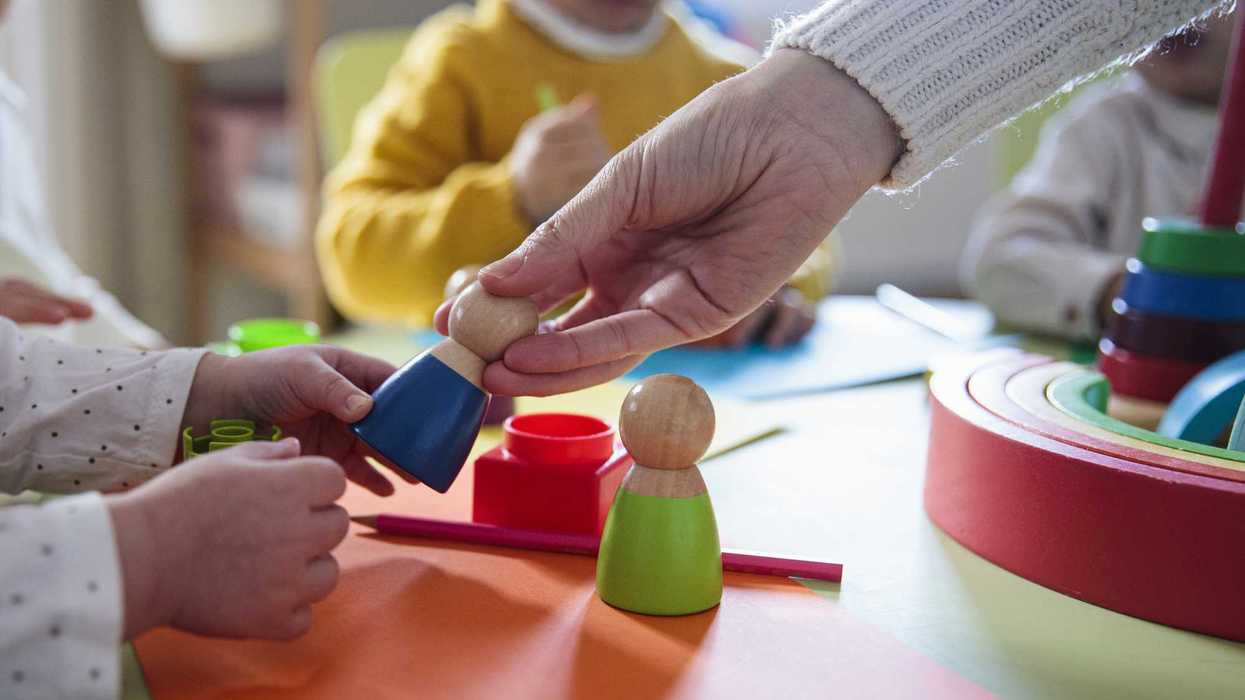 Preschool children playing with colorful shapes